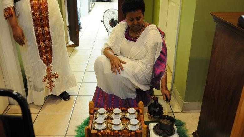 Woman making Ethiopian coffee