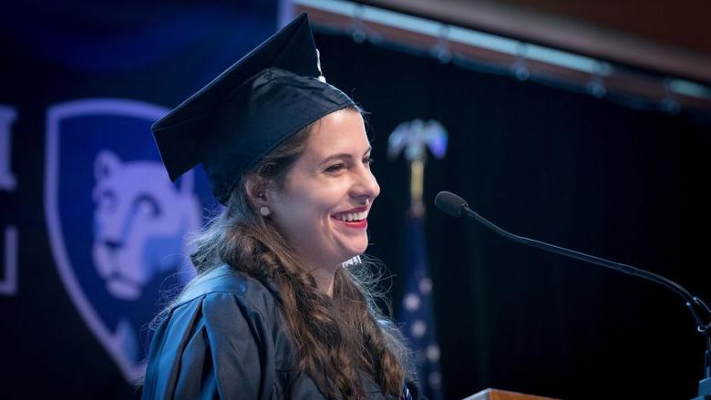 Woman speaking at commencement ceremony at a podium