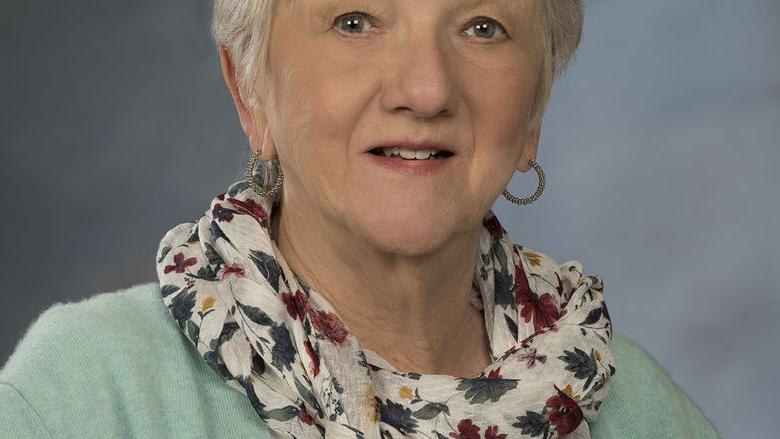 head shot of woman with scarf