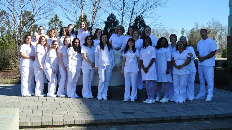 Group of LPN graduations near lion shrine