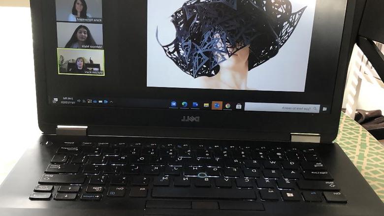 photo of laptop while on zoom event featuring artwork