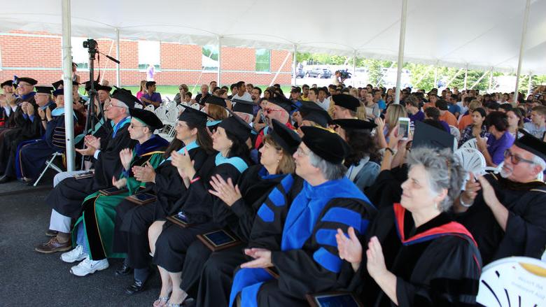 Group of faculty clap at convocation