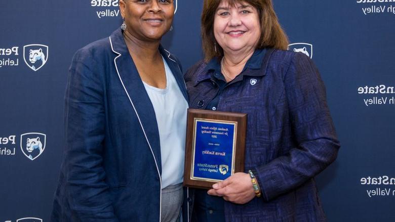 woman getting an award from another woman