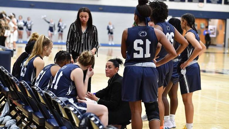 A group of women's basketball players in a huddle.