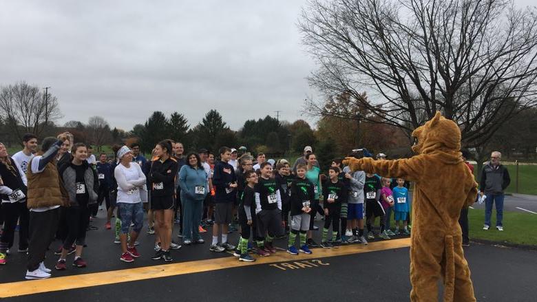 Nittany Lion pumps up crowd of runners