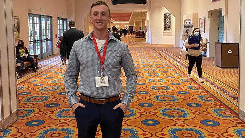 Trevor Faust stands at veterans conference 