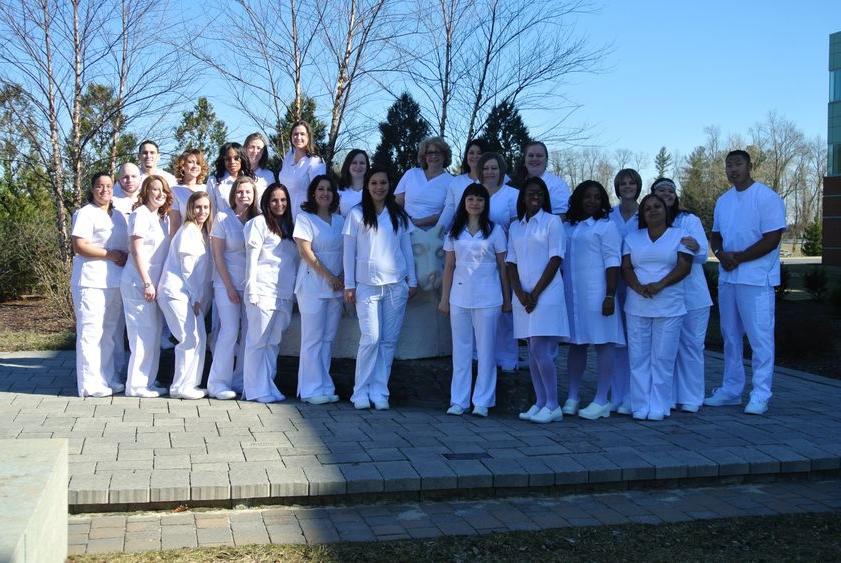 Group of LPN graduations near lion shrine